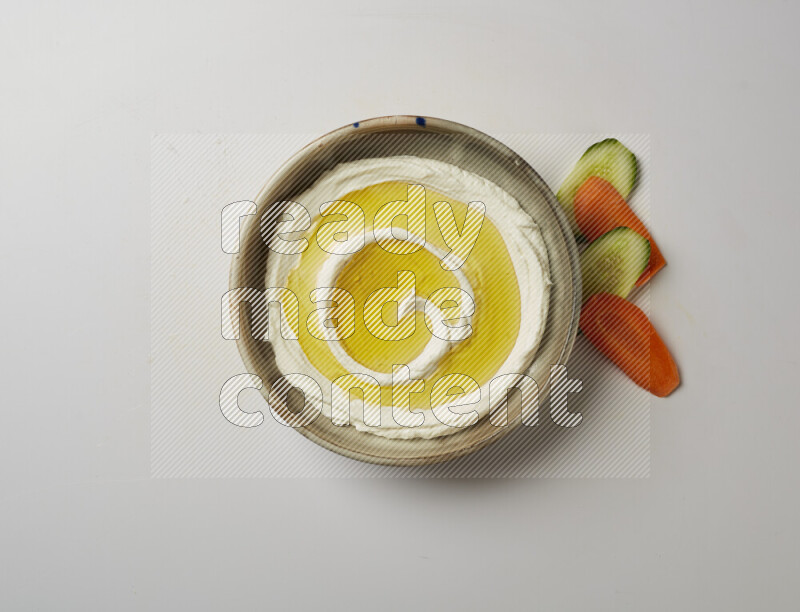 Lebnah garnished with olive oil in a grey pottery plate on a white background
