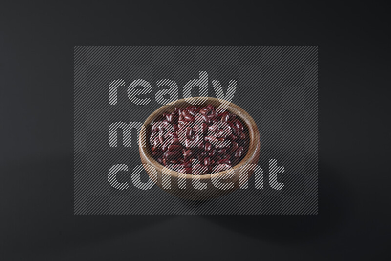 Red kidney beans in a wooden bowl on grey background