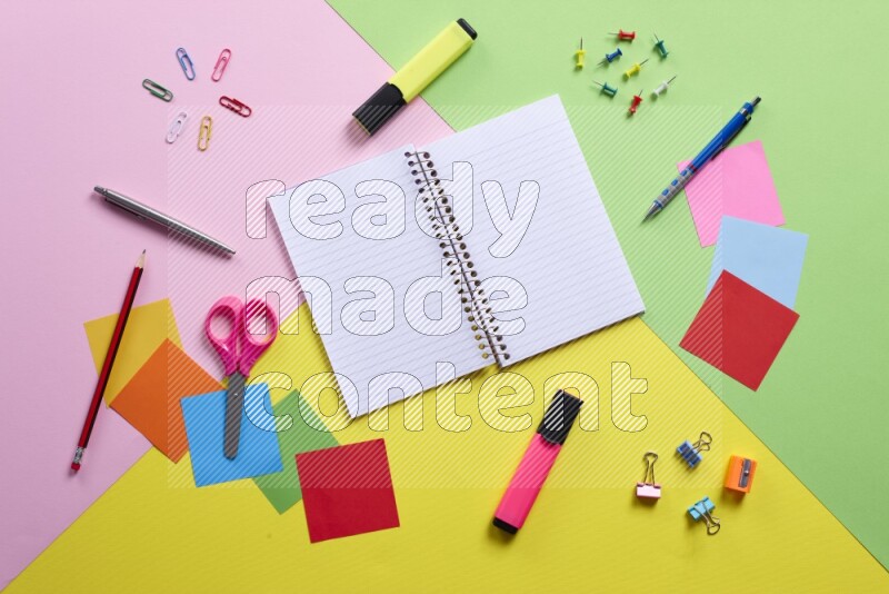 Different school supplies on multicolored background