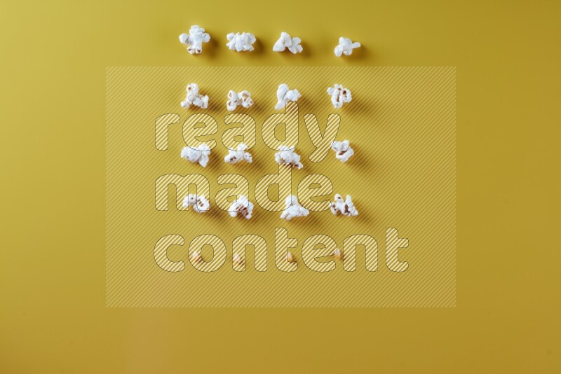 Popcorn flakes and seeds on a yellow background in different angles