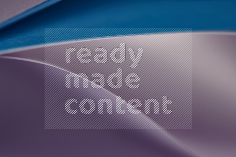 An abstract art showing purple and blue paper sheets arranged in an overlapping curves