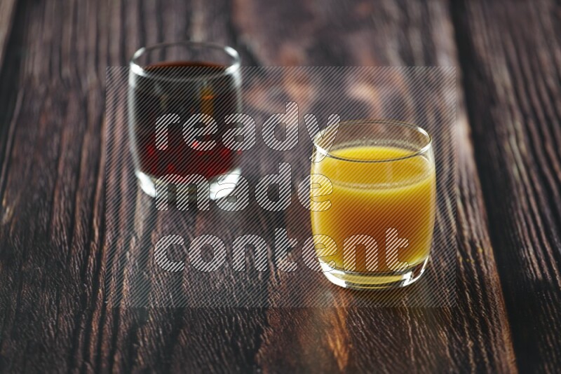 Cold drinks in a glass cup such as water, tamarind, qamar eldin, sobia, milk and hibiscus on wooden background