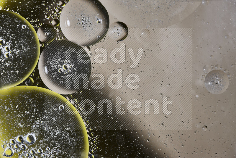 Close-ups of abstract oil bubbles on water surface in shades of brown, black and yellow