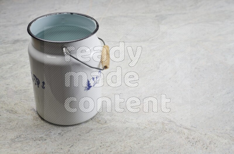 A vintage milk can on grey marble background