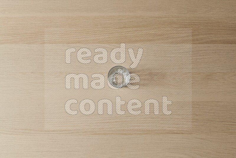 An empty glass cup on light wooden background