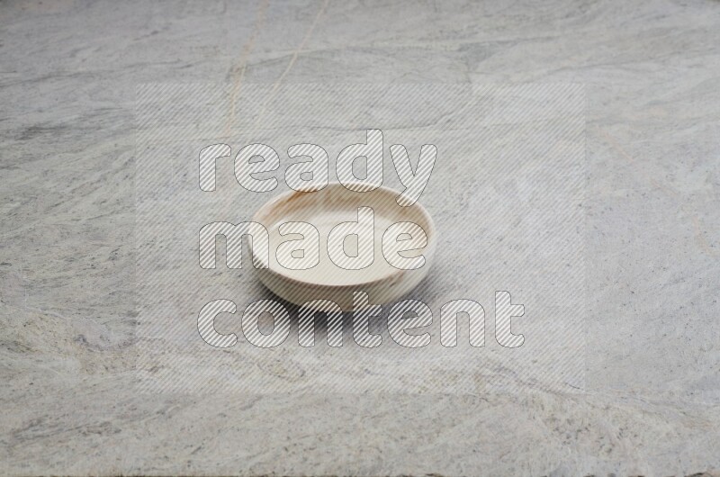 A multicolored pottery bowl on grey marble background