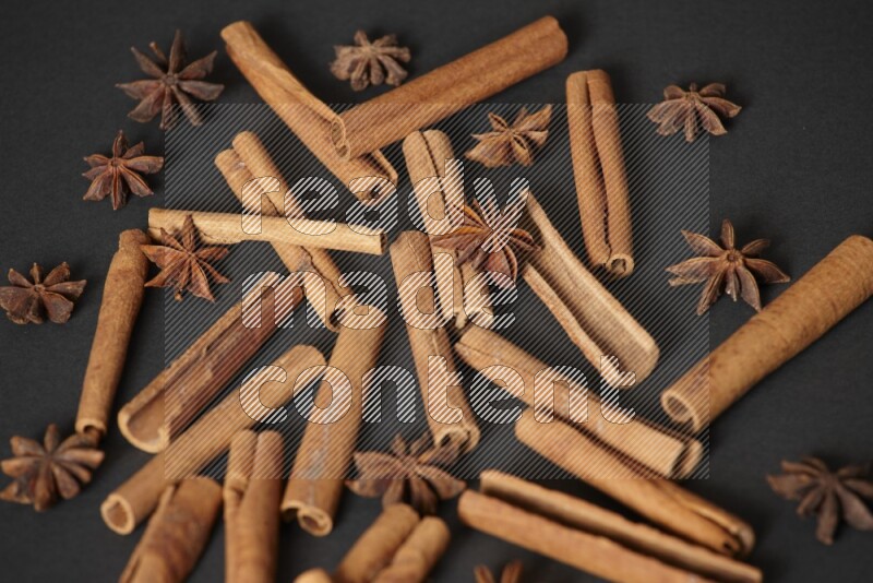 Cinnamon sticks and star anise on black background