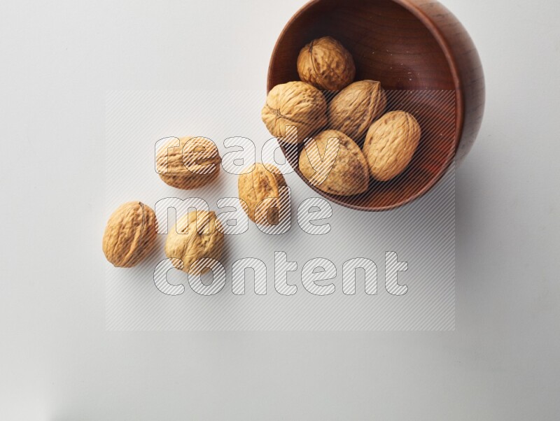 Top-view shot of walnut in a container on white background