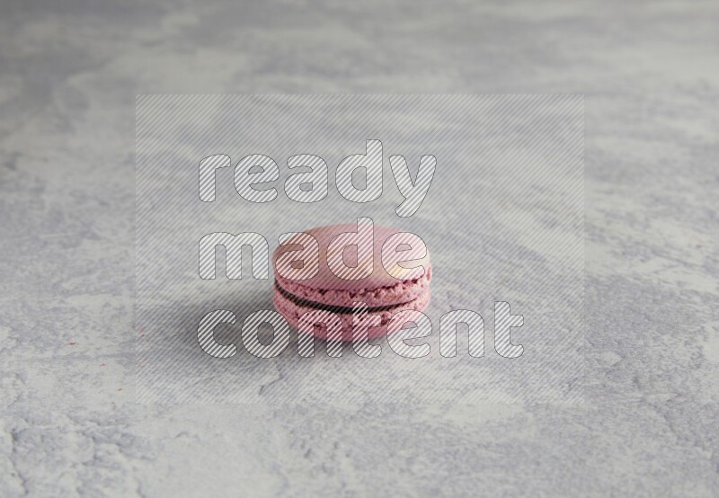 45º Shot of Purple Strawberry macaron on white  marble background