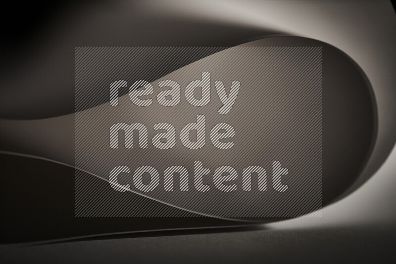 فن تجريدي يعرض منحنيات وتدرجات اللون الرمادي مكونه بضوء ملون