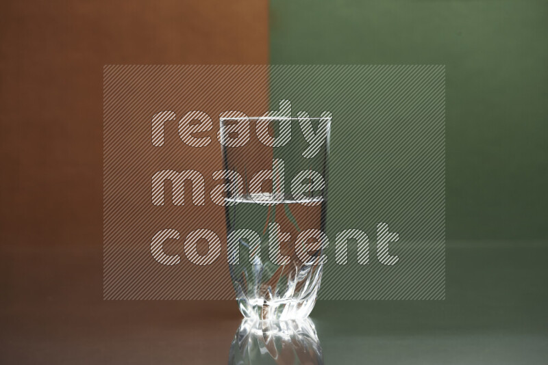 The image features a clear glassware filled with water, set against brown and dark green background