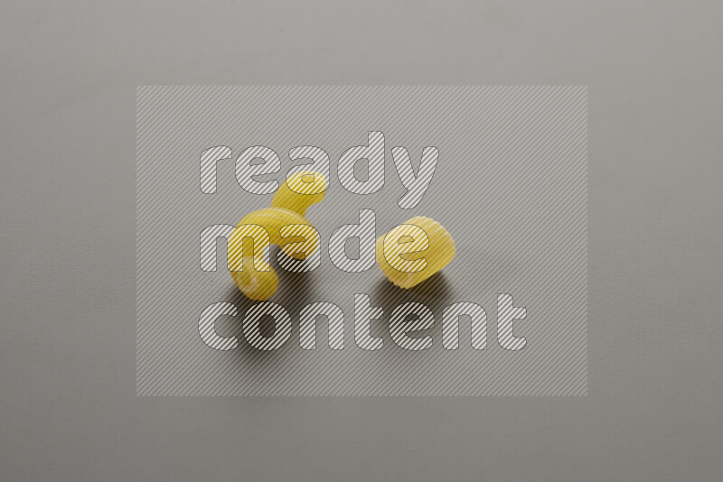 Twist pasta with other types of pasta on grey background