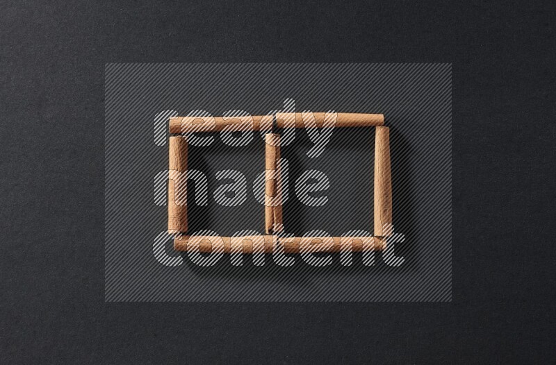 2 squares of cinnamon sticks on black flooring