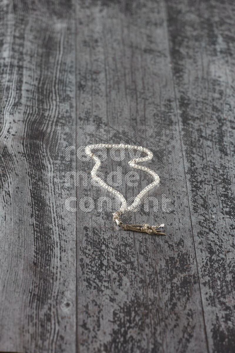 A prayer beads placed on wooden background