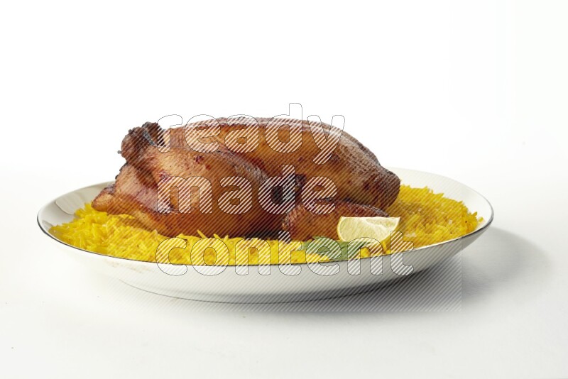 yellow  basmati Rice with kabsa chicken pieces on a white plate with a silver rim direct on white background