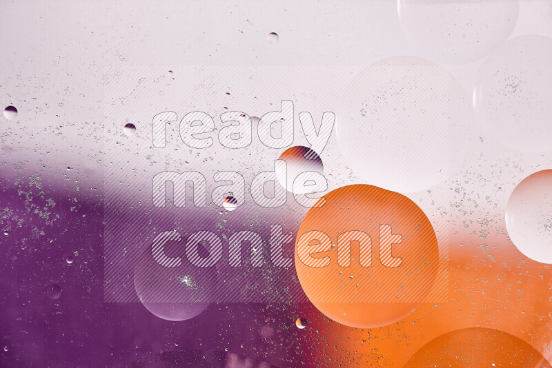 Close-ups of abstract oil bubbles on water surface in shades of white, orange and purple