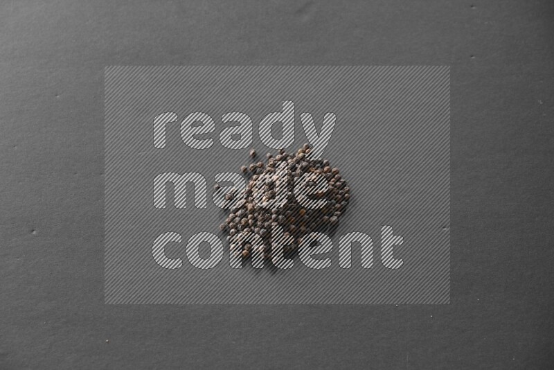 Black pepper on a black flooring