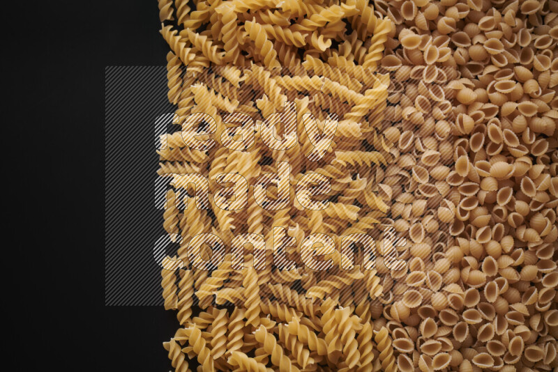 Different pasta types on black background
