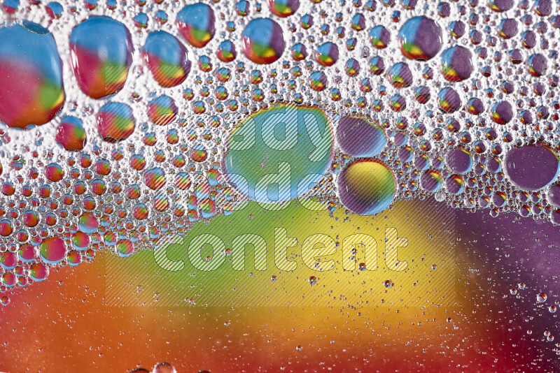 Close-ups of abstract soap bubbles and water droplets on multicolored background