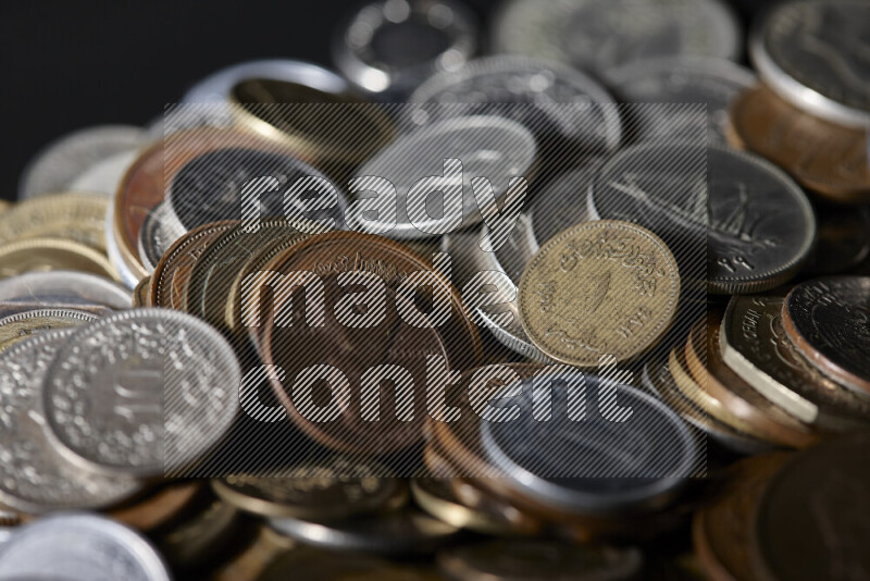A close-ups of random old coins on black background