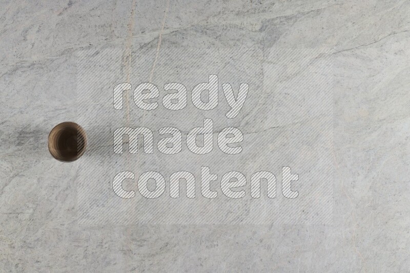 A multicolored pottery Cup on grey marble background