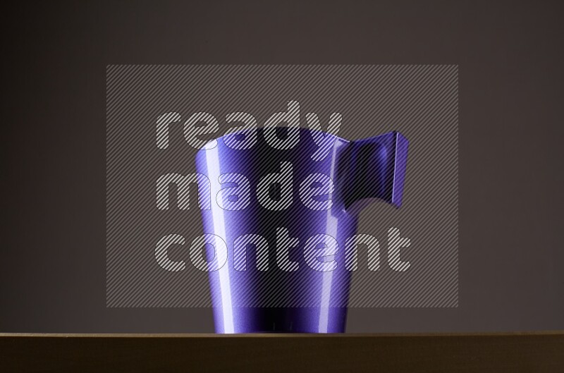 Low angle shot of a purple cup on grey background