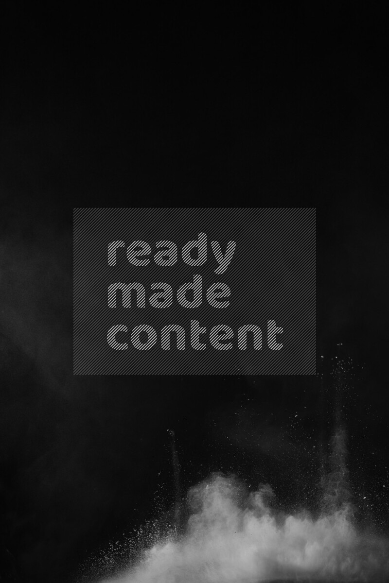 A side view of white powder explosion on black background
