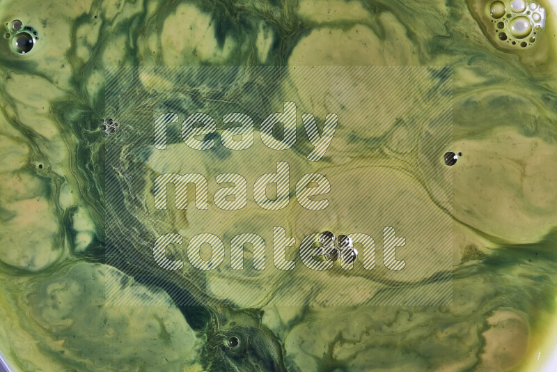 A close-up of abstract swirling patterns in orange and green