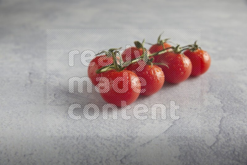 Red cherry tomato vein on a light grey textured background 45 degree